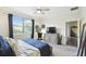 Comfortable bedroom featuring a large window, gray dresser and contemporary design providing ample natural light at 2980 Dayton Dr, Winter Haven, FL 33884