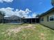 View of backyard with screened pool and patio with exterior of house to the side at 3022 Hickory Nw St, Winter Haven, FL 33881