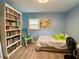 This cozy bedroom features a large bookcase and bright blue walls at 3022 Hickory Nw St, Winter Haven, FL 33881