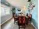 A dining room with a marble-topped table and a curated display of Gathering photos on the wall at 3022 Hickory Nw St, Winter Haven, FL 33881