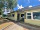 The home's exterior has a simple design and a small landscaped area near the entryway at 3022 Hickory Nw St, Winter Haven, FL 33881