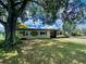 Charming single story home with a large tree in the front yard and driveway at 3022 Hickory Nw St, Winter Haven, FL 33881