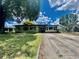Charming single-story home with a well-maintained lawn, mature trees, and a concrete driveway at 3022 Hickory Nw St, Winter Haven, FL 33881