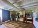 Rustic living room provides fireplace with nice wood flooring and great ceiling decor at 3022 Hickory Nw St, Winter Haven, FL 33881