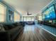Spacious living room with wood paneling, ample seating, and a large screen television at 3022 Hickory Nw St, Winter Haven, FL 33881