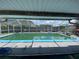 A screened in pool with lounge chairs on the pool deck and a backyard fence visible at 3022 Hickory Nw St, Winter Haven, FL 33881