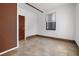 Bedroom with neutral walls, tile floors, and a window letting in lots of natural light at 305 Armour Ave, Auburndale, FL 33823