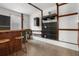 Modern kitchen with black appliances, open shelving, and black marble backsplash at 305 Armour Ave, Auburndale, FL 33823