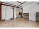 Bright living room features neutral walls, tile floors, and modern wood beam architectural details at 305 Armour Ave, Auburndale, FL 33823