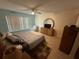 Spacious bedroom with a ceiling fan, accent chair, and tile floors at 333 Lake Howard Nw Dr # 103C, Winter Haven, FL 33880
