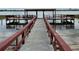 Waterfront dock featuring covered seating area with great lake views at 333 Lake Howard Nw Dr # 103C, Winter Haven, FL 33880