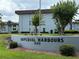 Exterior view of Imperial Harbours complex, showing the sign, landscaping, and the building's facade at 333 Lake Howard Nw Dr # 103C, Winter Haven, FL 33880