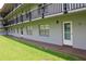 Exterior view of the building, showcasing the balconies, windows, and gray facade at 333 Lake Howard Nw Dr # 103C, Winter Haven, FL 33880