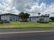 Exterior shot of the complex, with large trees on a well-maintained lawn at 333 Lake Howard Nw Dr # 103C, Winter Haven, FL 33880
