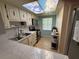 Bright kitchen with faux sky ceiling, stainless steel appliances, and neutral backsplash at 333 Lake Howard Nw Dr # 103C, Winter Haven, FL 33880