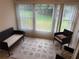 Bright sunroom featuring large windows with a view of the backyard and comfortable seating at 333 Lake Howard Nw Dr # 103C, Winter Haven, FL 33880