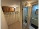 Walk-in closet leading to the bathroom features storage space and tile floors at 333 Lake Howard Nw Dr # 103C, Winter Haven, FL 33880