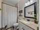 Cozy bathroom features a granite countertop and a decorative mirror above the toilet at 3805 Mammoth Grove Rd, Lake Wales, FL 33898