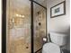 Modern bathroom featuring a glass enclosed shower with tile surround, plus a commode, and framed wall art at 3805 Mammoth Grove Rd, Lake Wales, FL 33898