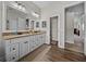 Bathroom vanity features double sinks and a doorway leading to the toilet and carpeted hallway at 3805 Mammoth Grove Rd, Lake Wales, FL 33898