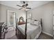 Carpeted bedroom with a four-poster bed, ceiling fan, and a doorway leading to an exterior door at 3805 Mammoth Grove Rd, Lake Wales, FL 33898