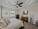 Spacious bedroom with a large bed, a flat-screen TV, and two dressers for ample storage at 3805 Mammoth Grove Rd, Lake Wales, FL 33898