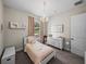 This charming bedroom features a lovely chandelier, white dresser and carpeted floors at 3805 Mammoth Grove Rd, Lake Wales, FL 33898