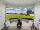 Dining room with a bay window offering stunning views of the green outdoor space at 3805 Mammoth Grove Rd, Lake Wales, FL 33898