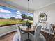 Dining room with a large bay window showcasing scenic views of the surrounding landscape at 3805 Mammoth Grove Rd, Lake Wales, FL 33898
