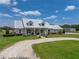 Beautiful home with a metal roof, manicured landscaping and inviting front porch at 3805 Mammoth Grove Rd, Lake Wales, FL 33898
