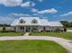 Charming exterior of a single-story home showcasing lush landscaping and a circular driveway at 3805 Mammoth Grove Rd, Lake Wales, FL 33898