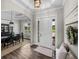 Elegant foyer showcasing dark wood floors, chandelier lighting, and a view into the dining area at 3805 Mammoth Grove Rd, Lake Wales, FL 33898