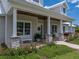 Inviting front porch featuring stone columns, benches, and beautifully landscaped garden at 3805 Mammoth Grove Rd, Lake Wales, FL 33898