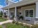 Inviting front porch featuring stone columns, benches, and beautifully landscaped garden at 3805 Mammoth Grove Rd, Lake Wales, FL 33898
