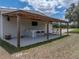 Outdoor space features a covered awning, bar, TV and seating at 3805 Mammoth Grove Rd, Lake Wales, FL 33898