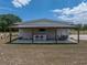 Detached garage with covered awning, bar, and outdoor seating, perfect for entertaining at 3805 Mammoth Grove Rd, Lake Wales, FL 33898