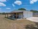Detached garage with covered awning, bar, and outdoor seating, perfect for entertaining at 3805 Mammoth Grove Rd, Lake Wales, FL 33898