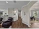 Hallway showing wood floors, neutral walls, and archways, with views of dining and living areas at 3805 Mammoth Grove Rd, Lake Wales, FL 33898