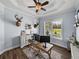 Home office with light blue walls, a ceiling fan, and a large window with outdoor views at 3805 Mammoth Grove Rd, Lake Wales, FL 33898