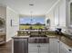 Bright kitchen with stainless steel appliances, undermount sink, granite countertops and a view of the backyard at 3805 Mammoth Grove Rd, Lake Wales, FL 33898