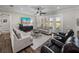 Bright living room featuring wood floors, neutral furniture, and French doors to the backyard at 3805 Mammoth Grove Rd, Lake Wales, FL 33898
