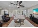 Spacious living room with wood floors, ceiling fan, and multiple doorways at 3805 Mammoth Grove Rd, Lake Wales, FL 33898