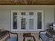 Covered patio with brick floors, ceiling fan, comfortable seating, and a view of the open grounds at 3805 Mammoth Grove Rd, Lake Wales, FL 33898