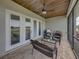 Outdoor patio with a view of the open grounds, ceiling fan, brick floors, and comfortable seating at 3805 Mammoth Grove Rd, Lake Wales, FL 33898