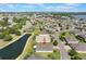 Aerial view of home in a community near a pond with lush landscaping at 3844 Bedford Ave, Winter Haven, FL 33884
