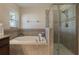 Bathroom featuring soaking tub, shower, and window for natural light at 3844 Bedford Ave, Winter Haven, FL 33884