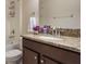 Bathroom vanity featuring granite countertops, a modern faucet, and a decorative mirror at 3844 Bedford Ave, Winter Haven, FL 33884