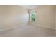 Cozy bedroom with neutral carpet and natural light from the window at 3844 Bedford Ave, Winter Haven, FL 33884