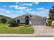 Charming single-story home featuring a well-maintained lawn, a brick-paved driveway and a two-car garage at 3844 Bedford Ave, Winter Haven, FL 33884