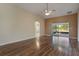 Open-concept living room featuring hardwood floors, ceiling fan, and access to outdoor patio at 3844 Bedford Ave, Winter Haven, FL 33884
